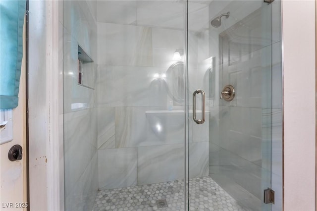 bathroom with a shower with door