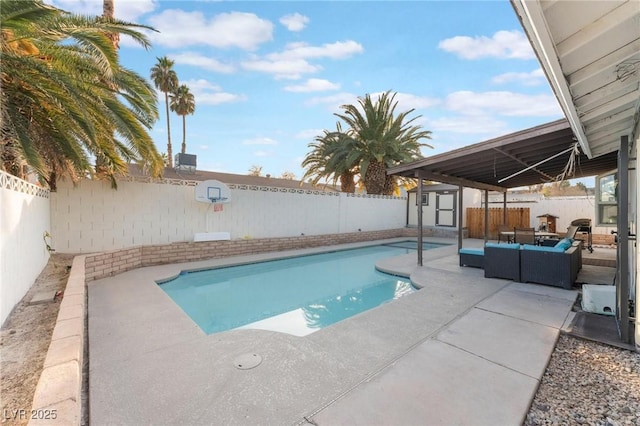 view of pool with a storage unit, an outdoor hangout area, and a patio