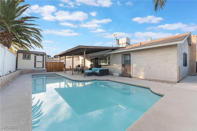 view of pool featuring a patio area, a shed, and an outdoor hangout area