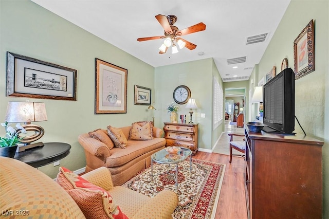 living room with ceiling fan and light hardwood / wood-style floors