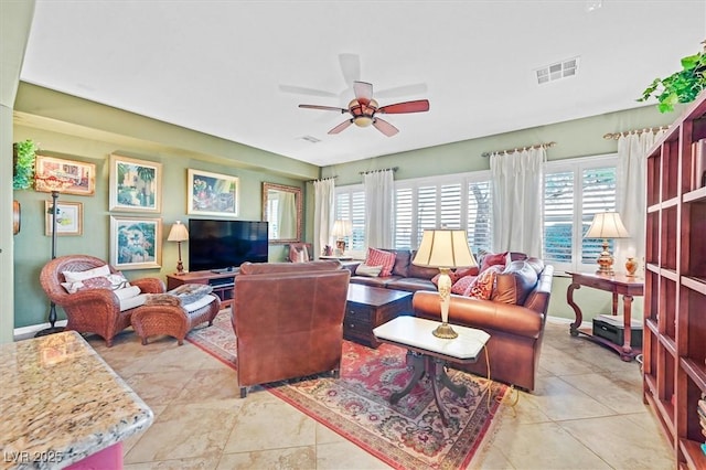 living room featuring ceiling fan and light tile patterned floors