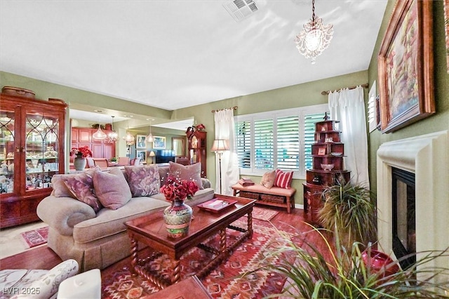 living room with wood-type flooring and a notable chandelier