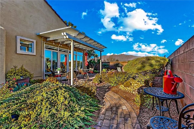 view of patio / terrace featuring a mountain view and a pergola