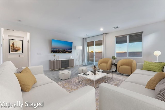 living area featuring recessed lighting and visible vents