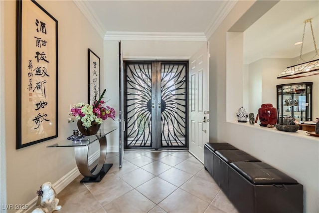 tiled foyer featuring ornamental molding and french doors