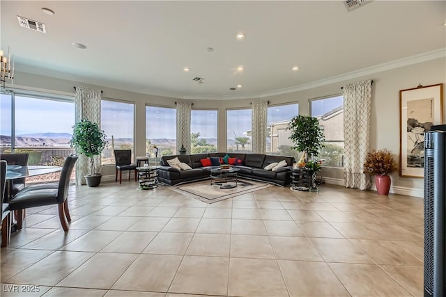 tiled living room with ornamental molding and a mountain view