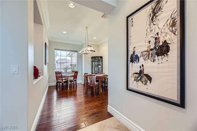 hallway featuring hardwood / wood-style flooring and crown molding