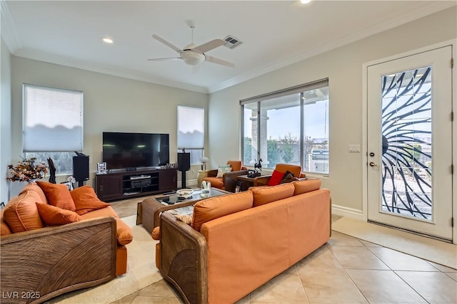 tiled living room with ornamental molding and ceiling fan