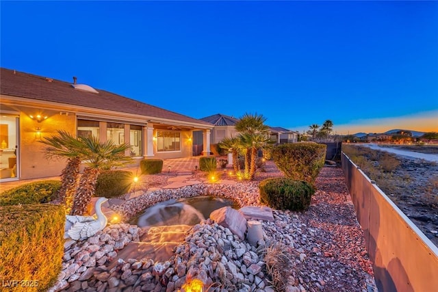 yard at dusk with a patio