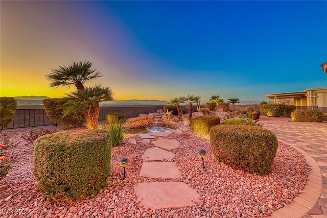 yard at dusk with a patio area