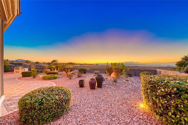 yard at dusk with a patio area