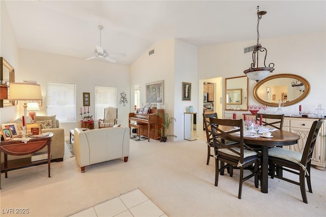 dining room featuring light carpet, ceiling fan, and lofted ceiling