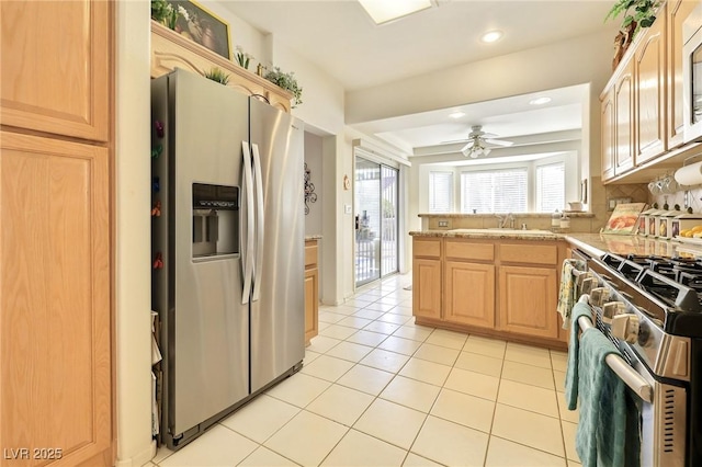 kitchen with ceiling fan, light brown cabinets, sink, light tile patterned flooring, and appliances with stainless steel finishes