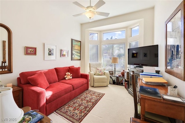 carpeted living room featuring ceiling fan