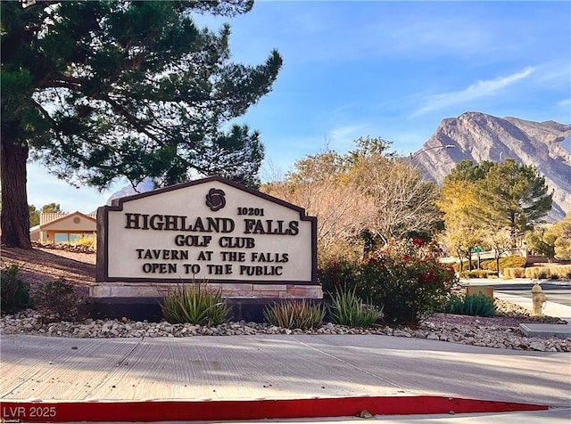 community sign with a mountain view