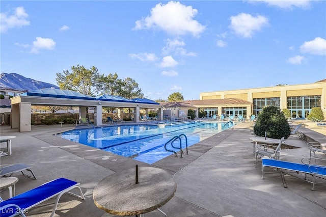 view of swimming pool featuring a mountain view, a gazebo, and a patio