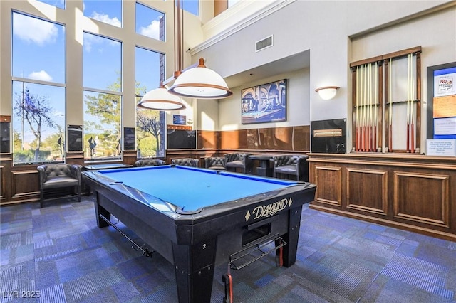 recreation room with dark colored carpet, a high ceiling, and billiards