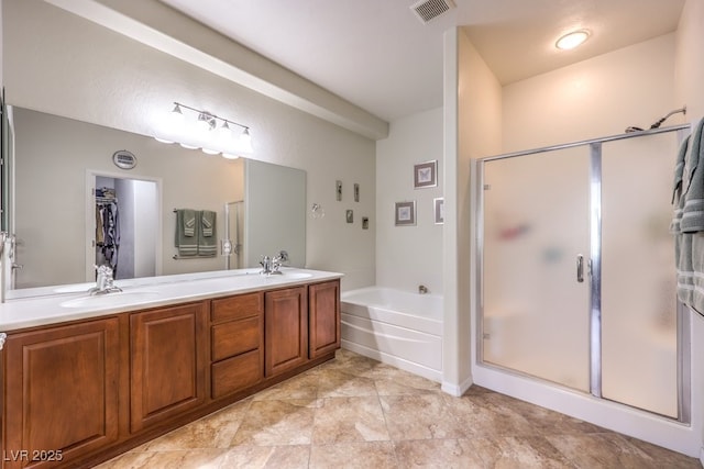 bathroom featuring vanity and shower with separate bathtub