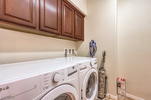 laundry area featuring cabinets and washer and clothes dryer