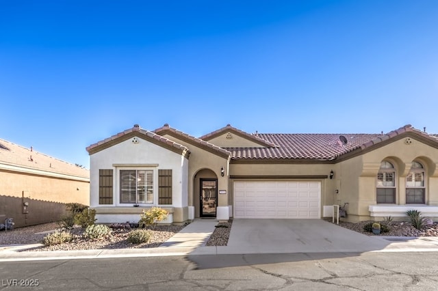 mediterranean / spanish-style house with a garage