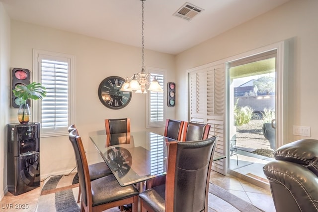 dining area featuring an inviting chandelier, plenty of natural light, and light tile patterned flooring