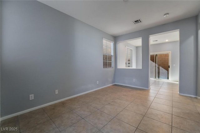 empty room with light tile patterned flooring