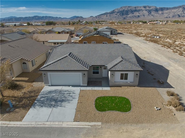 view of front of home with a mountain view and a garage