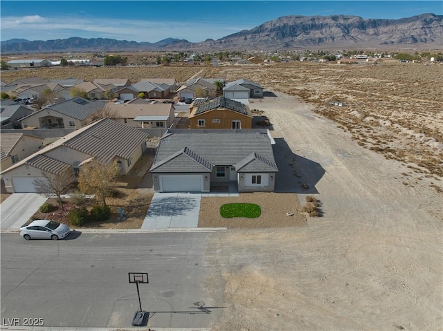 birds eye view of property with a mountain view