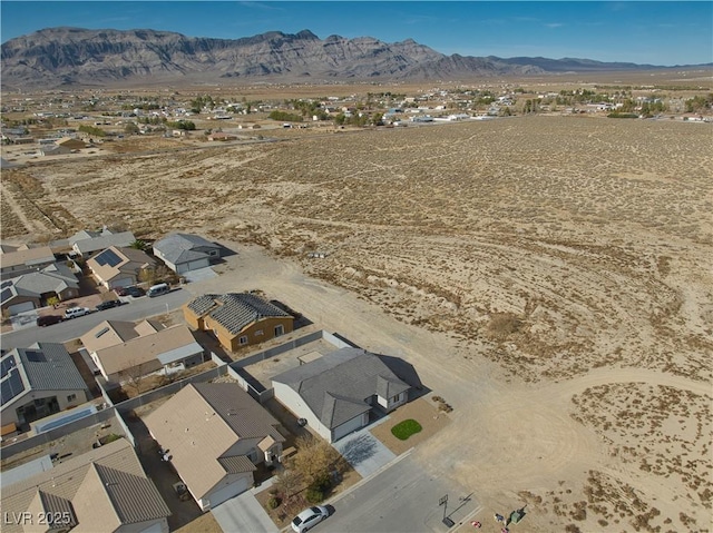 birds eye view of property with a mountain view