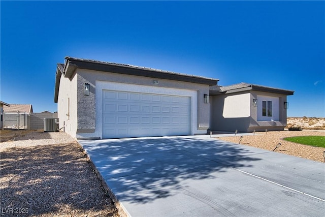 view of front of house with a garage and central AC unit