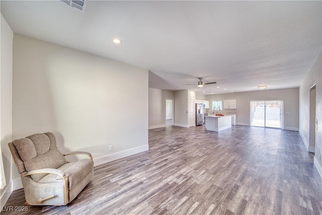 unfurnished room with light wood-type flooring and ceiling fan