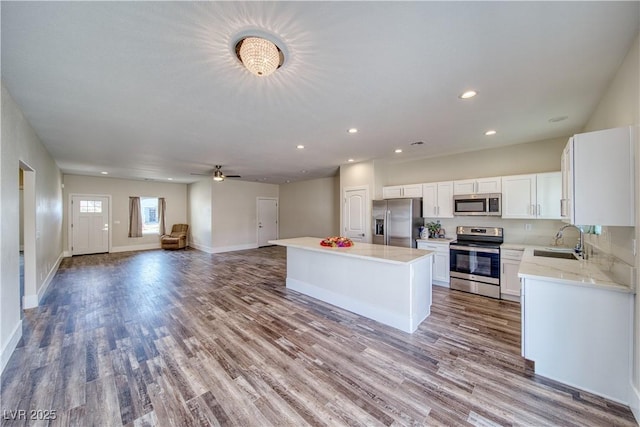 kitchen with a center island, white cabinetry, sink, and appliances with stainless steel finishes