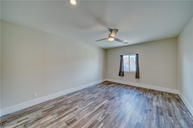 spare room with hardwood / wood-style floors and ceiling fan