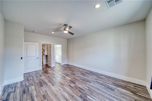 spare room with wood-type flooring and ceiling fan