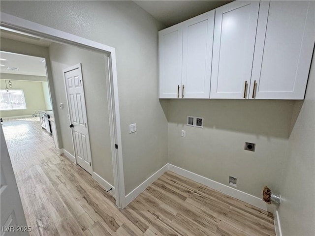 clothes washing area featuring electric dryer hookup, hookup for a washing machine, cabinets, and light wood-type flooring