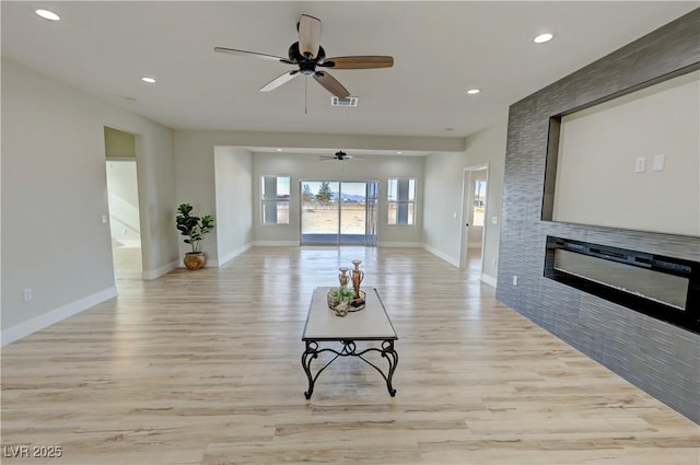 interior space with ceiling fan and light wood-type flooring