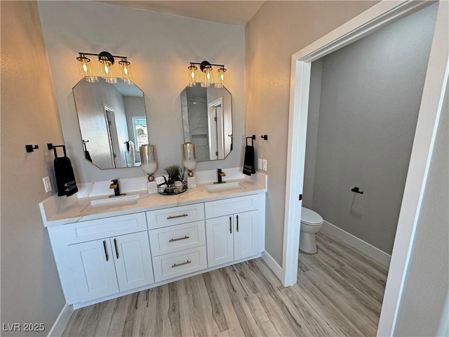 bathroom featuring hardwood / wood-style floors, vanity, and toilet