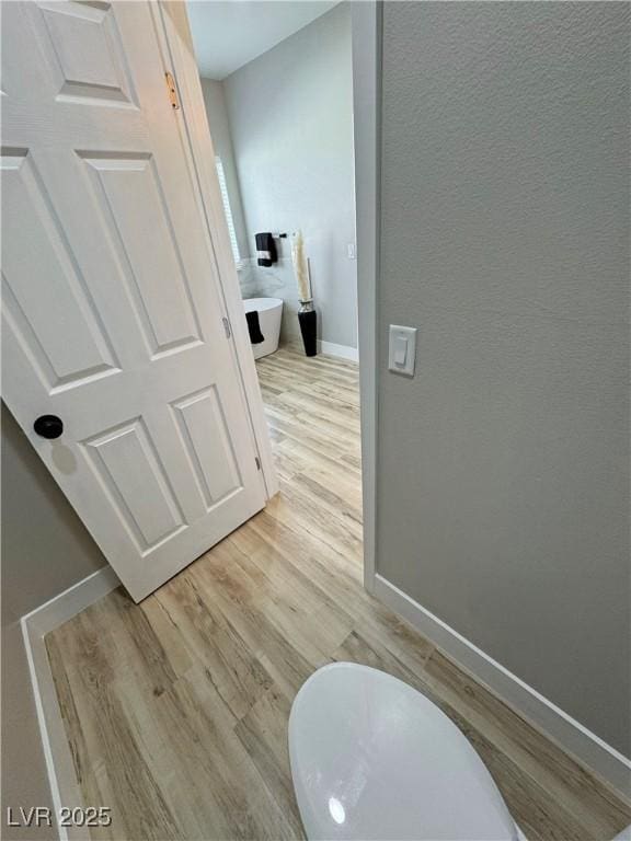 bathroom with hardwood / wood-style flooring