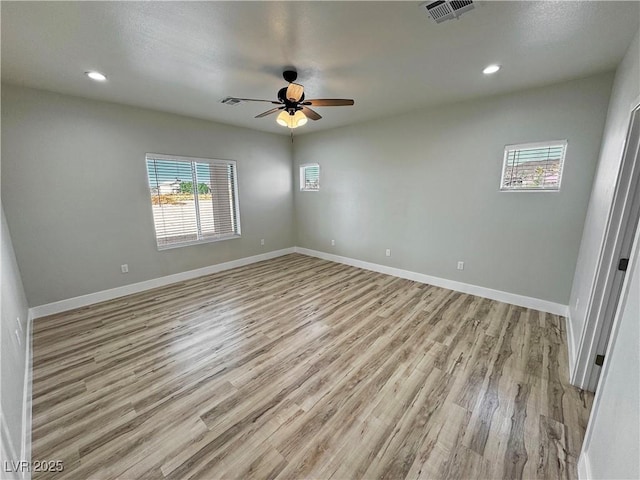 unfurnished room with ceiling fan and light wood-type flooring