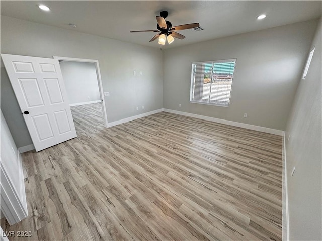 spare room featuring light hardwood / wood-style flooring and ceiling fan