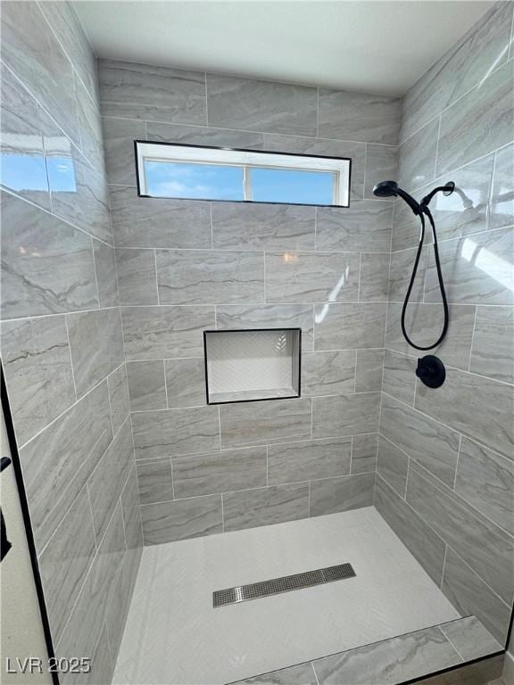 bathroom with tiled shower