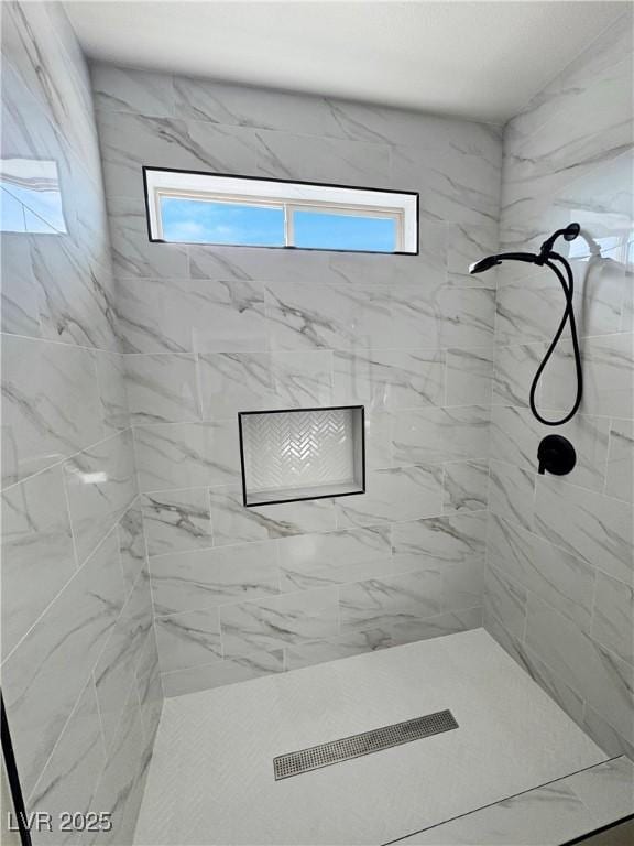 bathroom featuring tiled shower