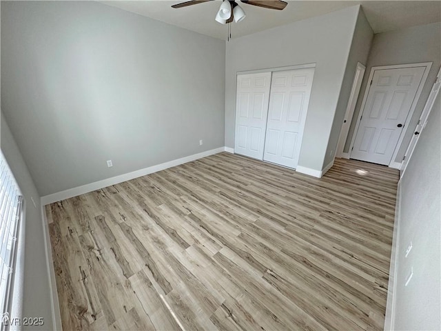 unfurnished bedroom featuring ceiling fan, a closet, and light wood-type flooring