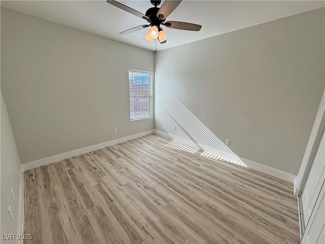 empty room featuring ceiling fan and light wood-type flooring