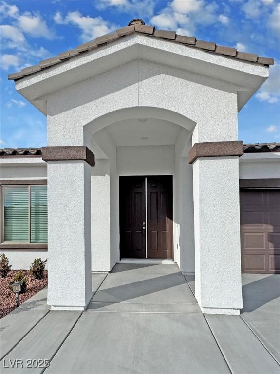 doorway to property featuring a garage