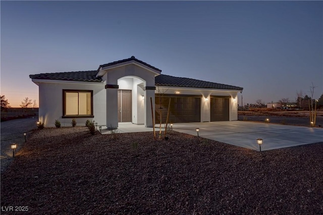 mediterranean / spanish-style home featuring a garage