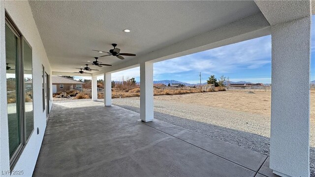 view of patio featuring a mountain view and ceiling fan