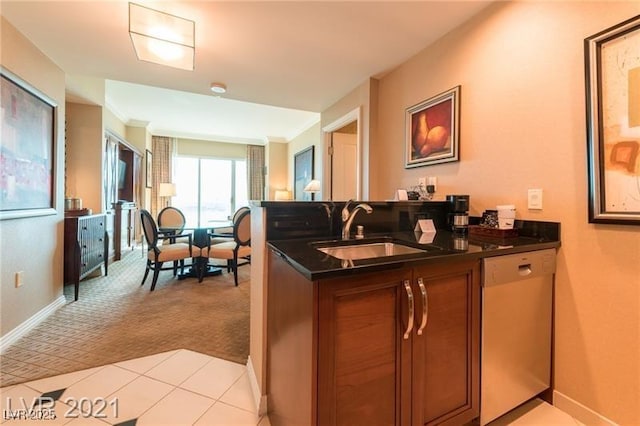 kitchen with dishwasher, light colored carpet, kitchen peninsula, and sink