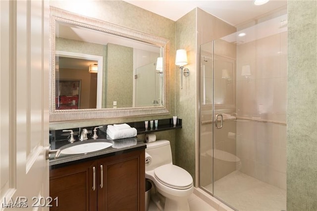 bathroom featuring vanity, toilet, and walk in shower