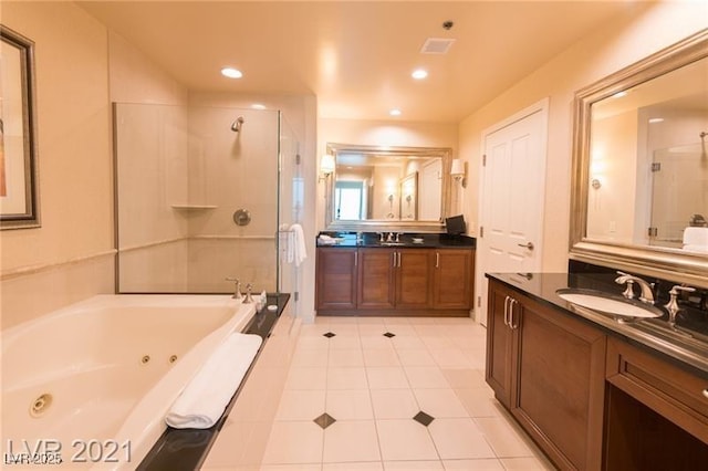 bathroom featuring vanity, tile patterned flooring, and plus walk in shower